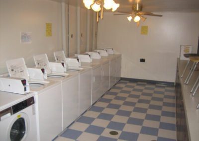 Image of washing machines and dryer aligned in a line