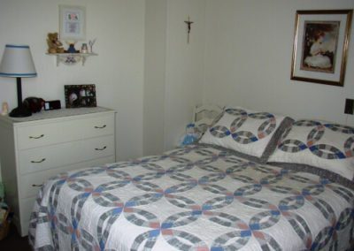 An image of the white coloured bed in the bedroom