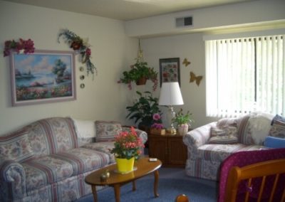 An image of a living room with sofas and table